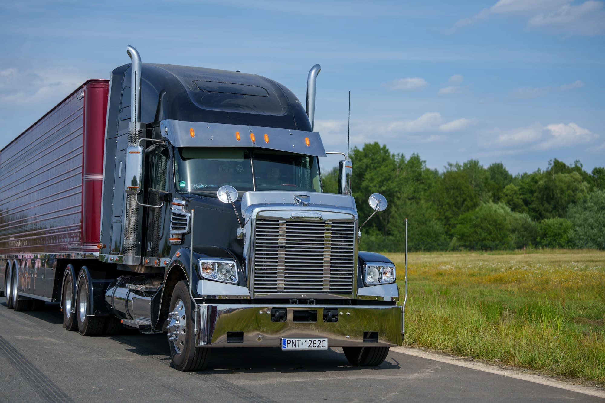 A conventional tractor trailer on the road